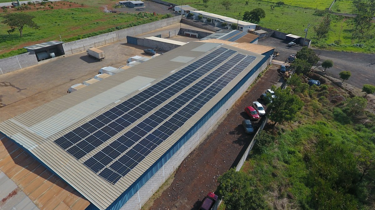 Solar panels installed across an industrial factory roof